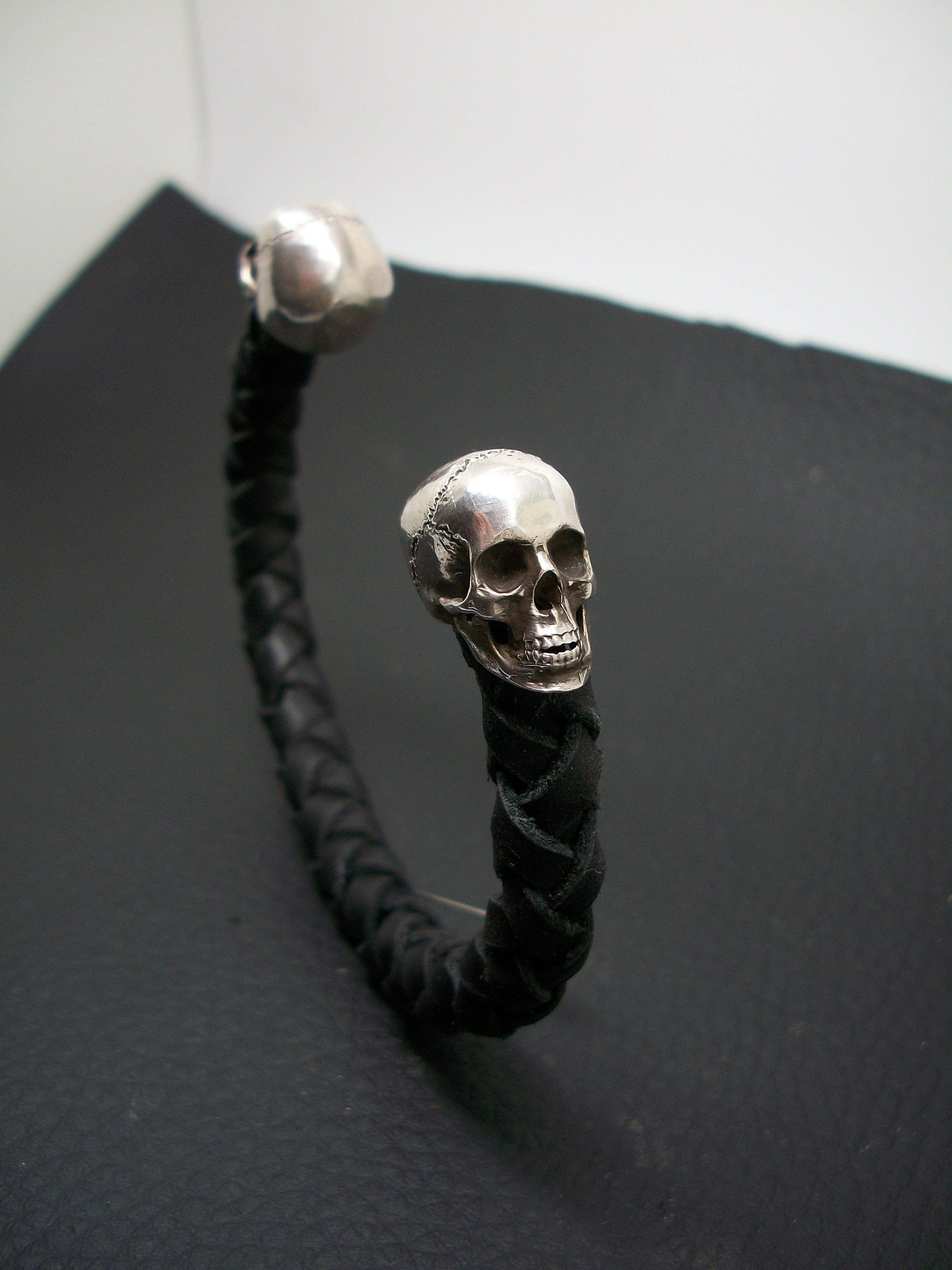 Skull Bracelet - Sterling Silver skulls - Black braided leather  - Open cuff